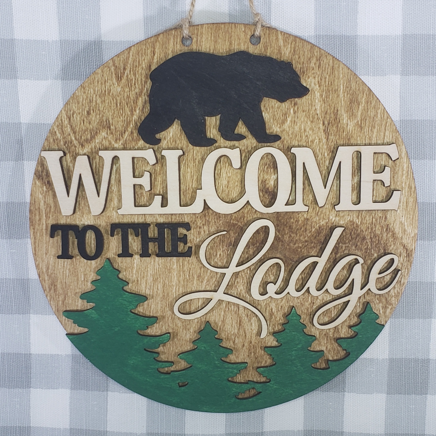 a wooden welcome sign hanging on a wall