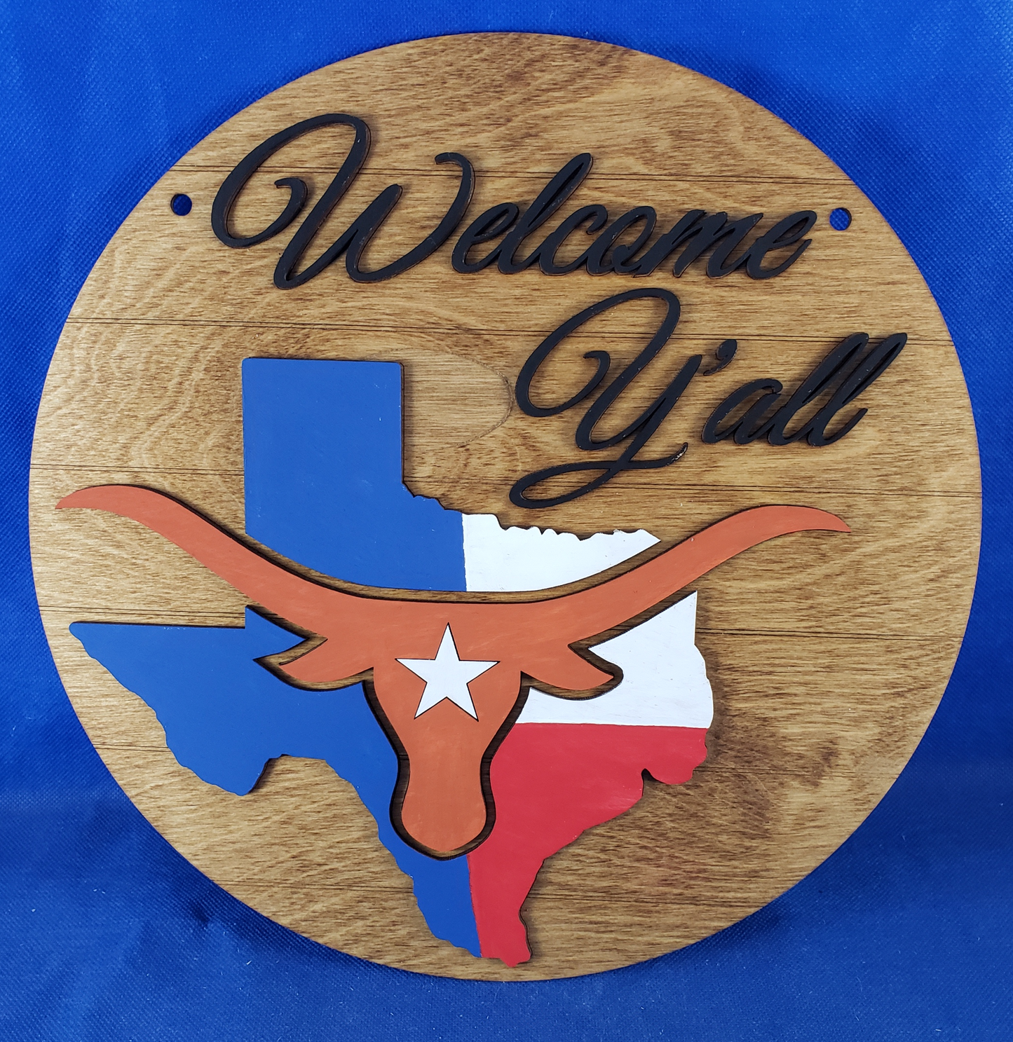 a wooden sign with a picture of a woman's face on it