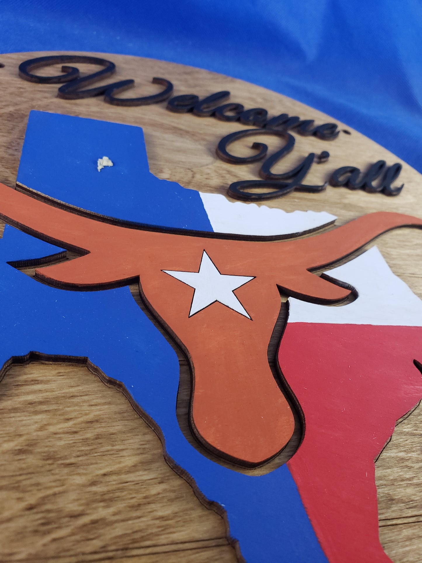 a close up of a sign on a wooden surface