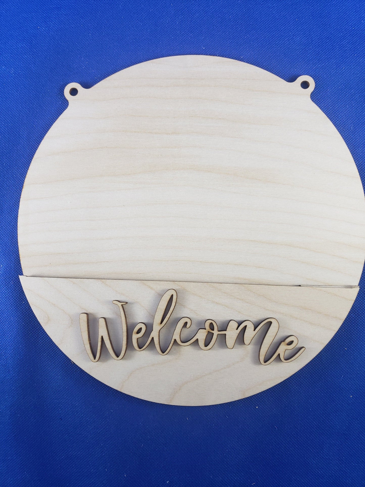 a wooden sign that says welcome on a blue background