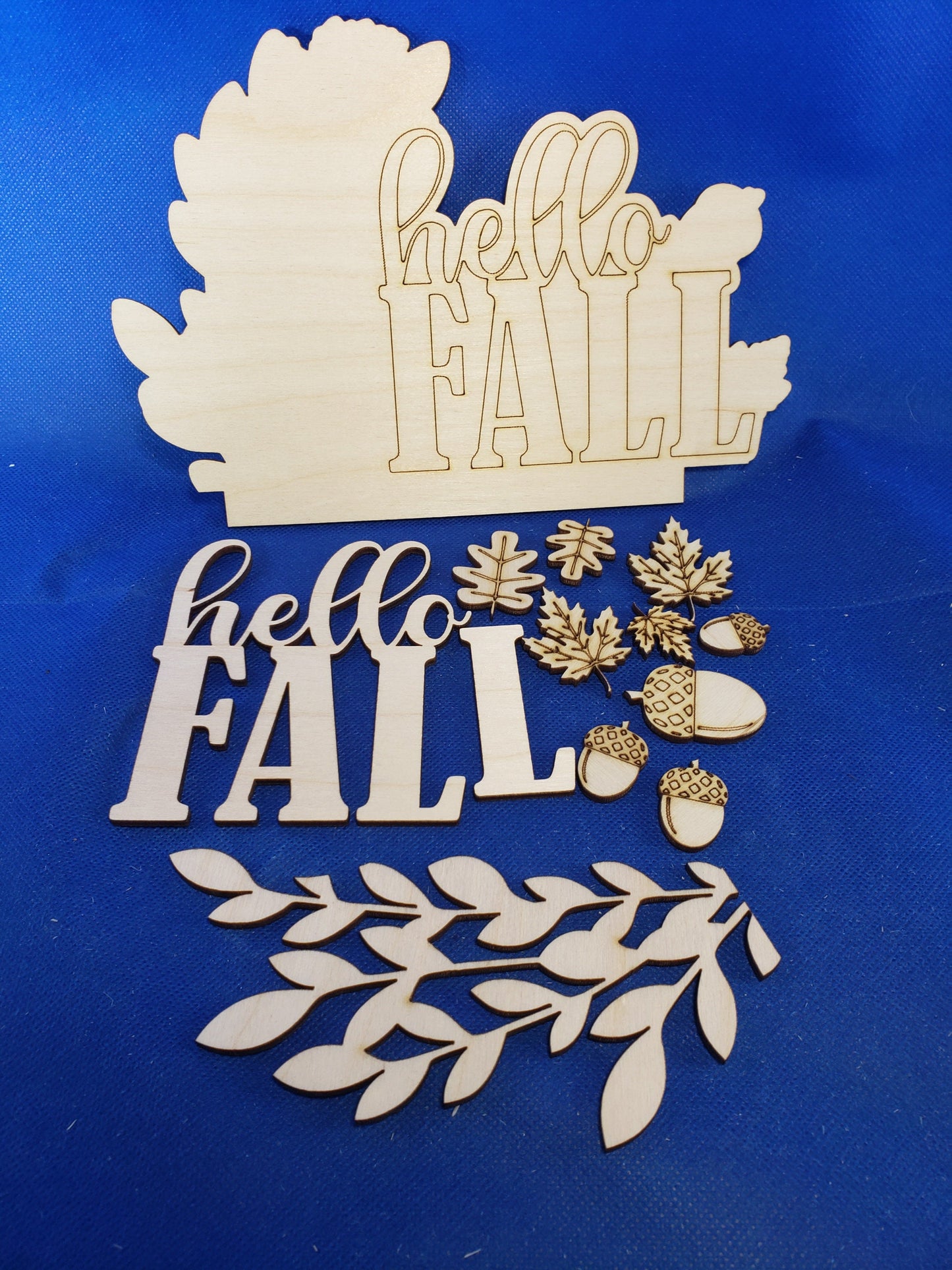 a cut out of wood that says happy fall